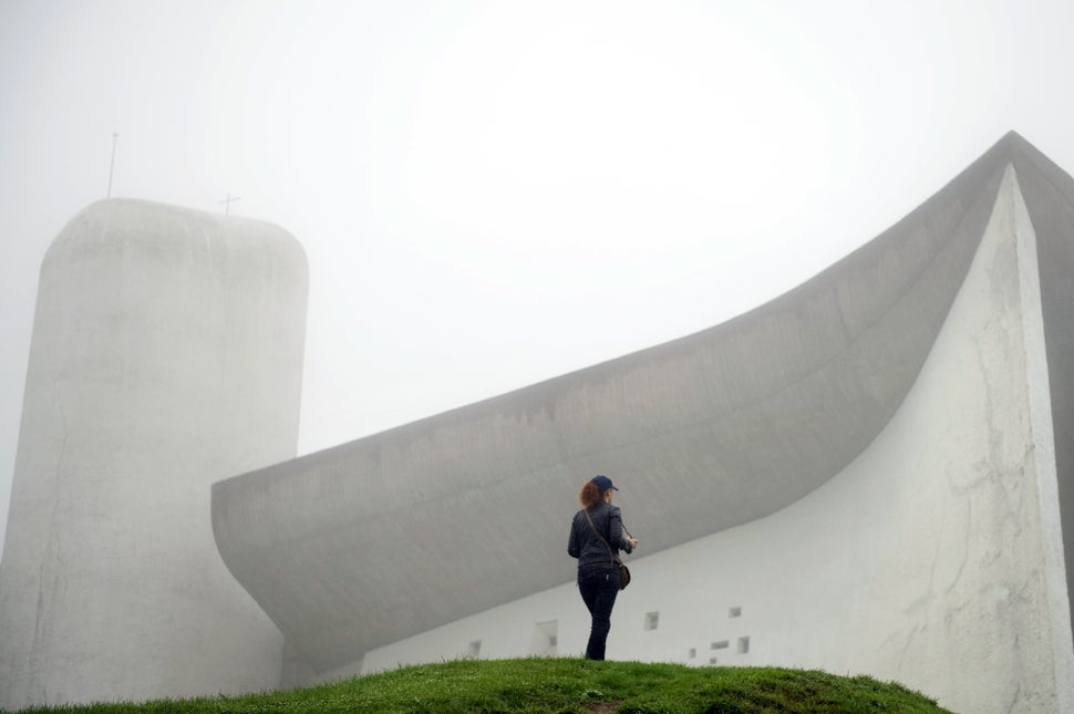 A visitor stands in front of Le Corbusier's Notre Dame du Haut chapel on Sept. 9, 2011, in Ronchamp, France. The chapel