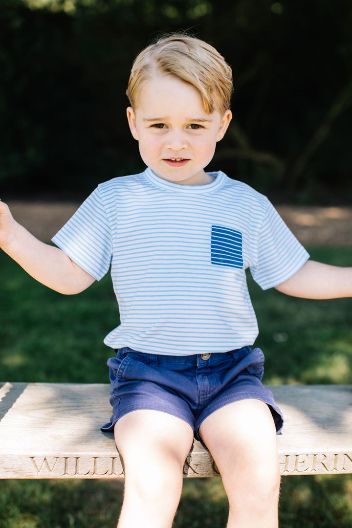 Prince George sits on a wooden swing, which is engraved with his parents' names, in one of the images.
