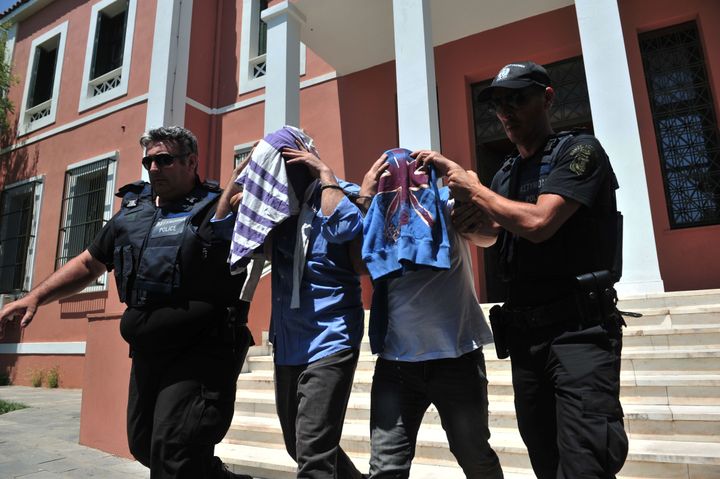 Two of the Turkish men leave the courthouse in Alexandroupoli after appearing before a Greek prosecutor on July 17. The eight military personnel, who arrived in Greece by Black Hawk helicopter, are seeking political asylum in the wake of Turkey's failed coup on Friday.