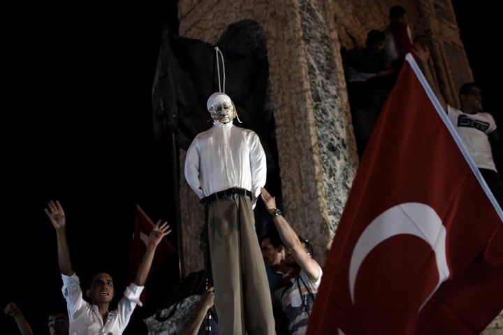 Pro-Erdogan supporters hang an effigy of U.S.-based preacher Fethullah Gulen at rally at Taksim Square in Istanbul