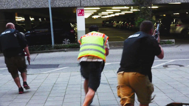 Police officers respond to a shooting at the Olympia mall in Munich, Germany, on Friday.