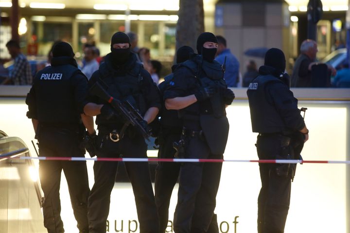 Special force police officers stand guard at an entrance of the main train station