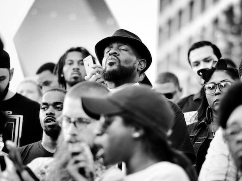 The author in meditation while standing upon the hill at Belo Garden Park in Downtown Dallas before addressing the rally