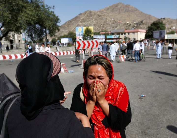 An Afghan woman weeps at the site of a suicide attack in Kabul on Saturday. The attack was claimed by the Islamic State milit