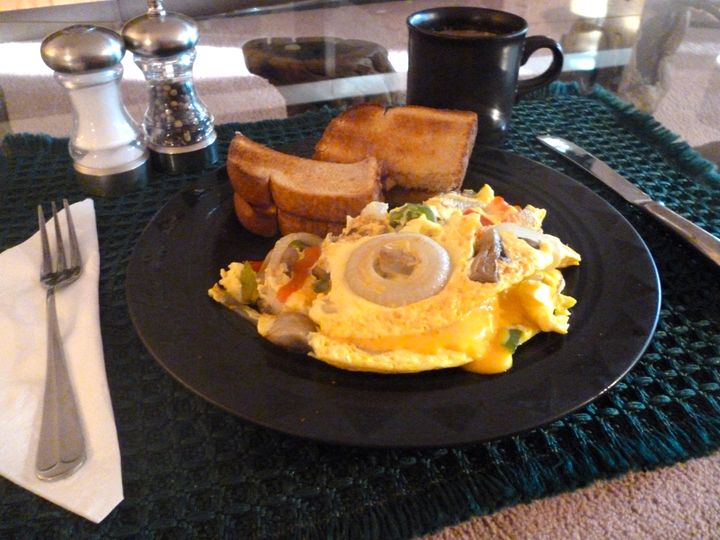 Veggie and cheese omelette with buttered toast and coffee with real cream: 321calories.