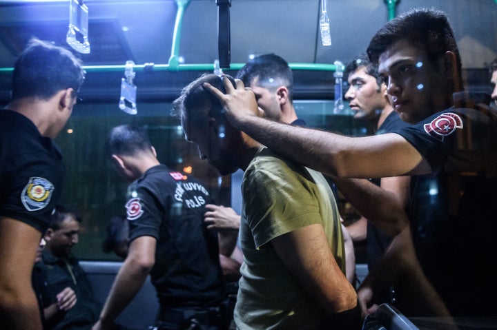 Turkish police detain a Turkish soldier in Istanbul on July 16 who allegedly took part in a military coup attempt.&nbsp;Leade