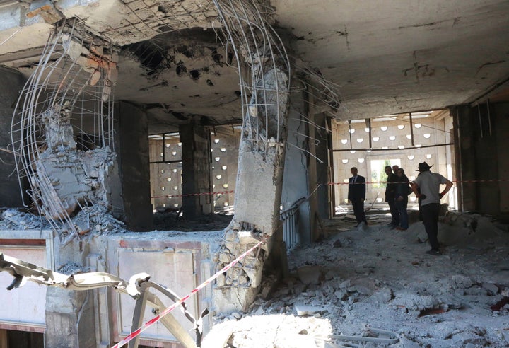 People inspect damage on July 16 after Turkey's parliamentary complex&nbsp;was bombed by rebel-flown jets in Ankara.&nbsp;At 