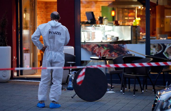 A police forensic expert works outside where a 21-year-old Syrian refugee killed a woman with a machete and injured two other people in the city of Reutlingen, Germany July 24, 2016.