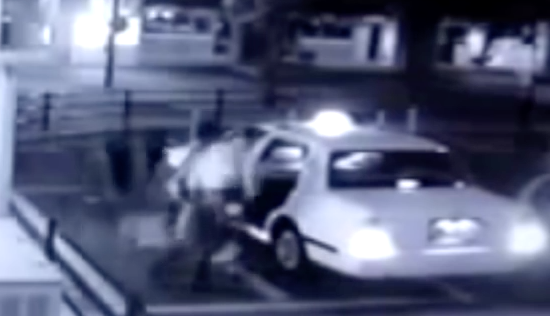 Does this footage show a ghostly passenger climbing into a taxi alongside a paying customer? 