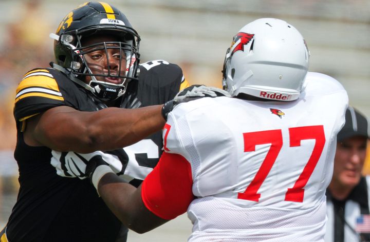 University of Iowa football player Faith Ekakitie (left) recently wrote a Facebook post detailing how he was held at gun point by Iowa City police officers. 