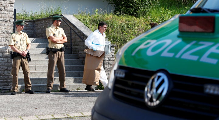 Policemen leave the flat of the 27-year-old Syrian suspect after an explosion in Ansbach near Nuremberg, Germany, July 25, 2016.