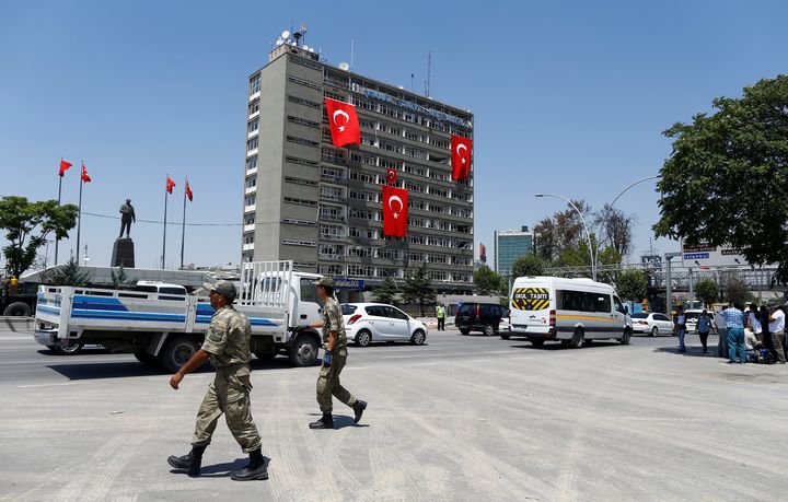 Turkish soldiers walk past by the police headquarters in Ankara, Turkey, July 18, 2016.
