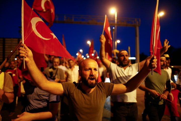 Pro-government demonstrators hold Turkish national flags and shout slogans during a march towards the Asian side of the Bosphorus Bridge in Istanbul.