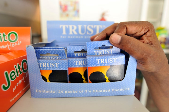 A customer picks a pack of condoms for sale at a chemist's on the outskirts of Maputo, March 19, 2009.