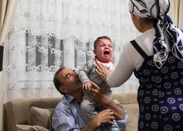 Celal with his second wife Kinda and their son Ahmet, now 2 years old, in a photo taken a year ago. Celal would only permit his second wife to be photographed from the back.