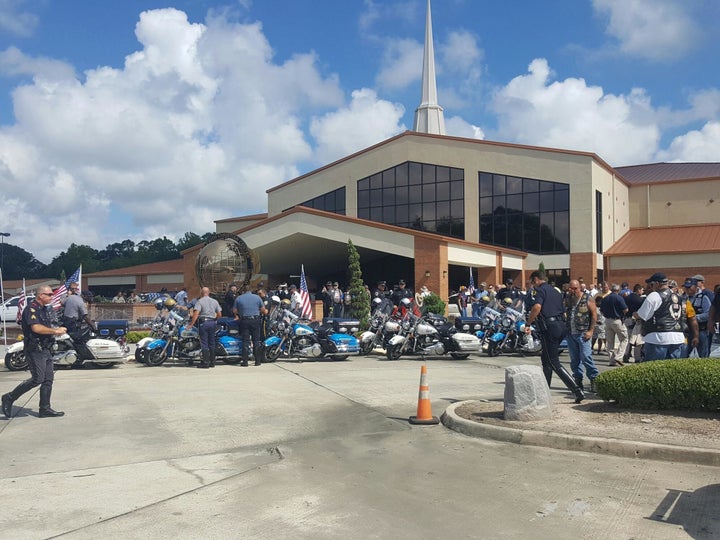 Police officers and mourners gather at Living Faith Christian Center in Baton Rouge to pay respects to Montrell Jackson.