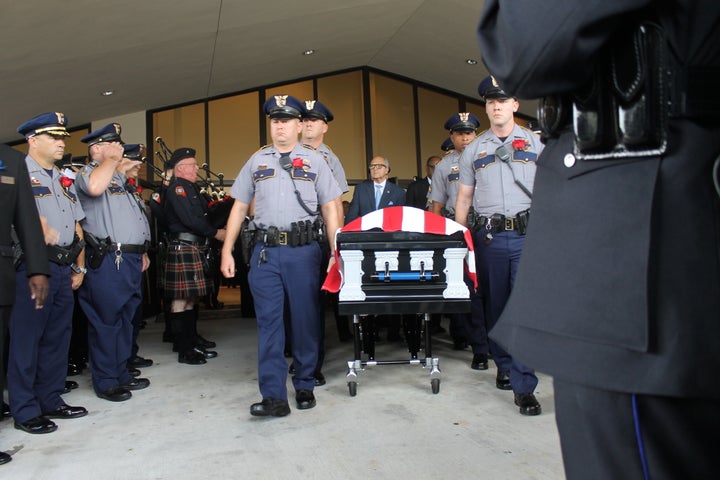 The casket for slain Baton Rouge police officer Montrell Jackson departs his funeral on Monday.