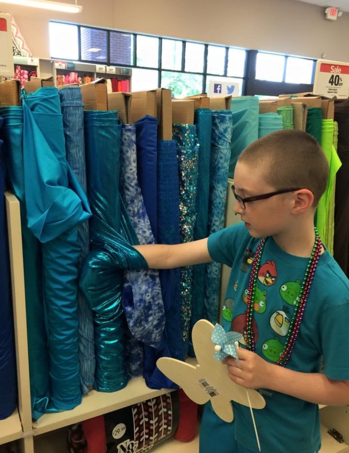 Admiring shiny fabrics at a favorite local fabric store