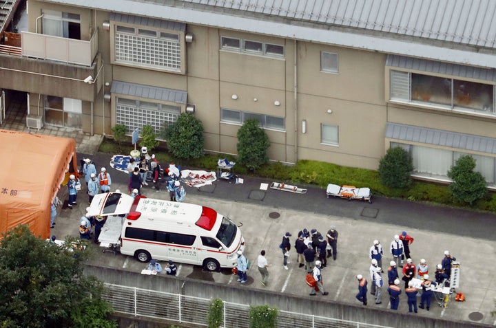 Police officers and rescue workers are seen at the disabled care home