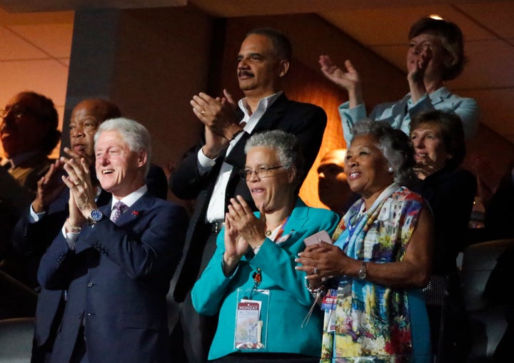 Former president Bill Clinton stands as he applauds Obama's speech 