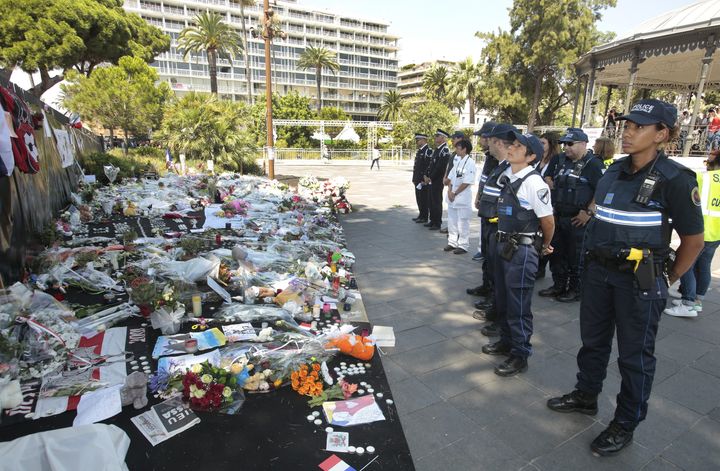 Police gather to observe a minute's silence in tribute to the victims of the deadly Nice attack at La Promenade des Anglais on July 18