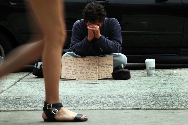 PHILADELPHIA, PA - SEPTEMBER 22: A homeless man panhandles on a street in downtown Philadelphia where Pope Francis is scheduled to visit on September 22, 2015 in New York City. The project, which features hundreds of 'knots', or prayer slips, seeks to represent the struggles individuals go through in life's journey. The Pope will be making his first trip to the United States on a three-city, five-day tour that will begin in Washington on September 22, then travel to New York City and Philadelphia. The Pope will depart on September 27. (Photo by Spencer Platt/Getty Images)