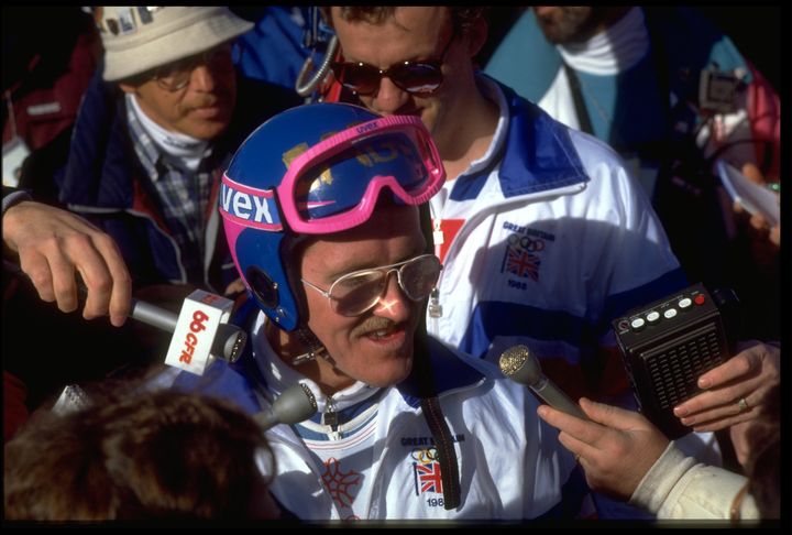 Eddie 'The Eagle' Edwards is mobbed by reporters during the 90m ski jump