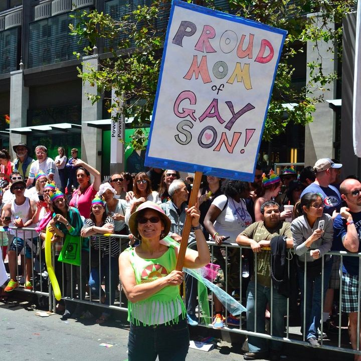 Laurin Mayeno holding her sign: "Proud Mom of Gay Son!" 
