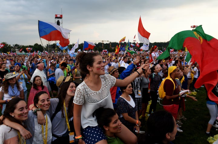 Pilgrims from all over the world celebrate after the Opening Mass on the first day of the World Youth Days, on the Blonia Meadows in Krakow, on July 26, 2016.