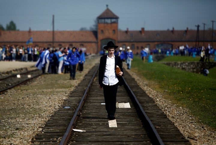 A man walks on the railway tracks in the former Nazi death camp of Auschwitz-Birkenau.