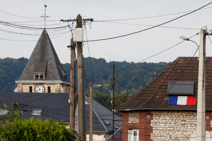 A French flag is seen on a rooftop near the bell tower of the church after a hostage-taking in Saint-Etienne-du-Rouvray near Rouen in Normandy, France.