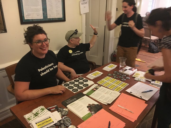 Rabbi Alissa Wise (left) of Jewish Voice for Peace distributes pamphlets at a panel discussion on Monday. Her shirt says, "Palestinians should be free."