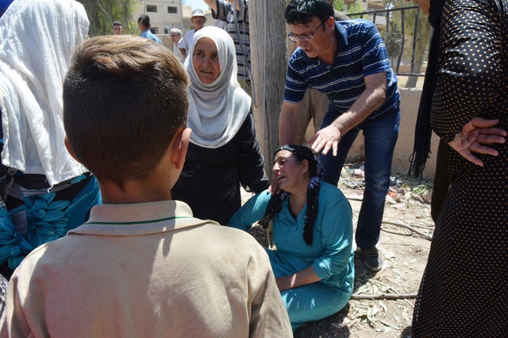 A woman mourns dead relatives in the northeastern Syrian city of Qamishli near the Turkish border, Syria July 27.