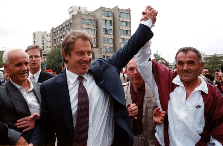 Tony Blair greets an ethnic Albanian in Pristina, Yugoslavia in July 1999