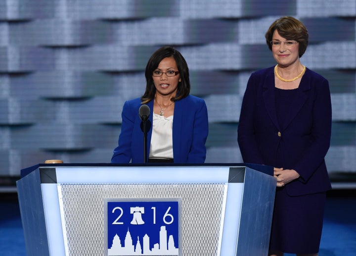 Human trafficking survivor, Ima Matul, speaks as US Senator Amy Klobuchar of Minnesota looks on during the second day of the Democratic National Convention at the Wells Fargo Center, July 26, 2016 in Philadelphia, Pennsylvania. / AFP / SAUL LOEB