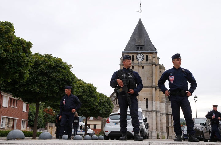 French CRS police stand guard in front of the church a day after a hostage-taking in Saint-Etienne-du-Rouvray near Rouen in Normandy, France.