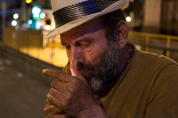 Papi lights a cigarette late at night.