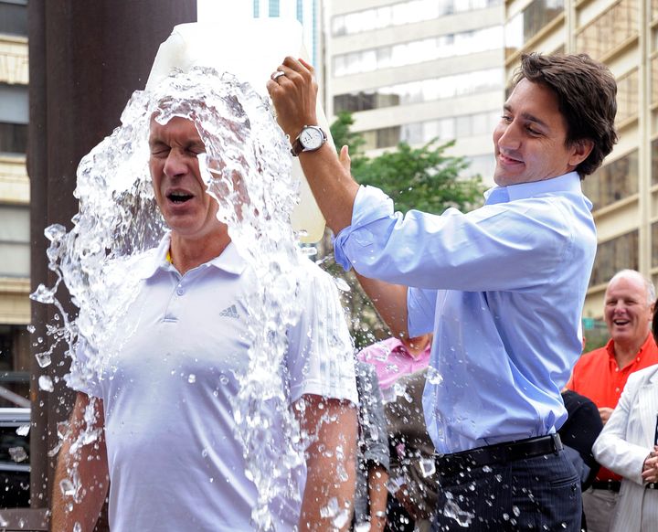 Justin Trudeau dumps a bucket of ice water onto Sean Casey for the ALS ice bucket challenge.