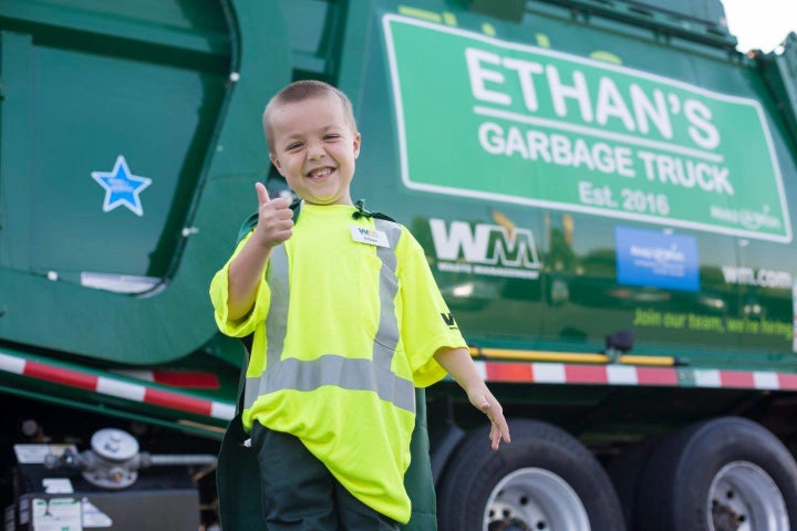 Ethan in front of his garbage truck. 