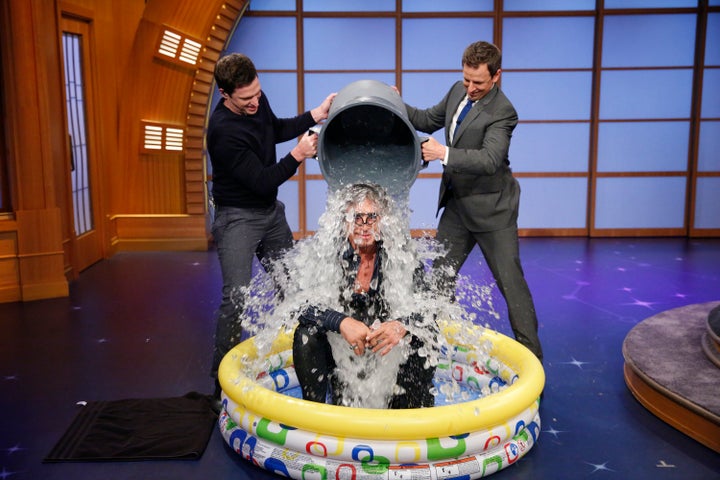 Seth Meyer dumps a bucket of ice on actor Mickey Rourke for the 'Ice Bucket Challenge.'