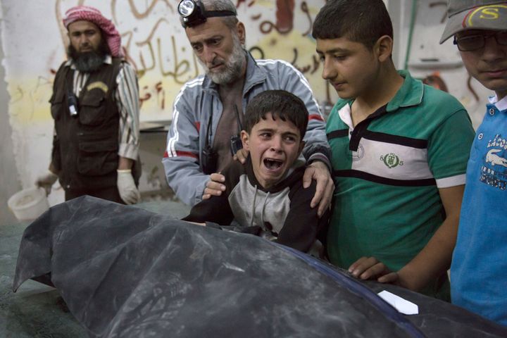 "When thinking of Syria, think of the people there, not about ISIS or Assad,” urges Syria Charity president Mohammad Alolaiwy. Above, a Syrian boy cries next to the body of a relative who died in a reported airstrike on April 27. 