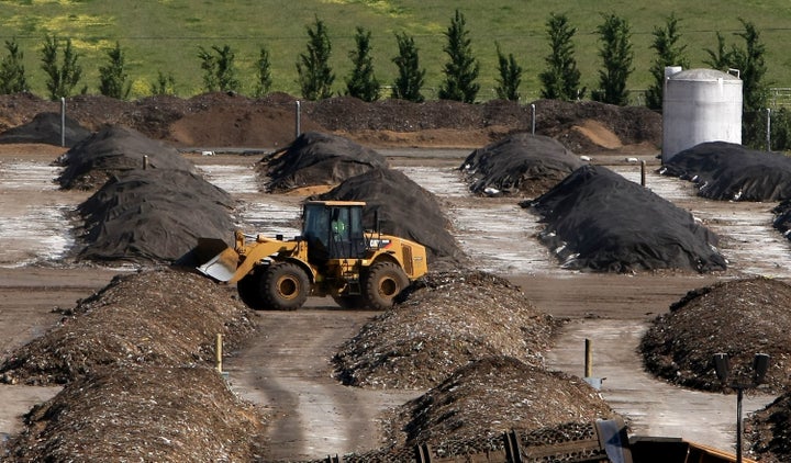 A tractor drives past piles of compost at a compost facility on April 20, 2009, in Vacaville, California.