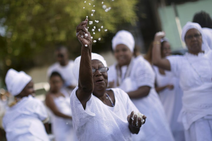 A Candomblé woman takes part in a protest against religious intolerance, along the streets of Salvador, Brazil November 15, 2015.