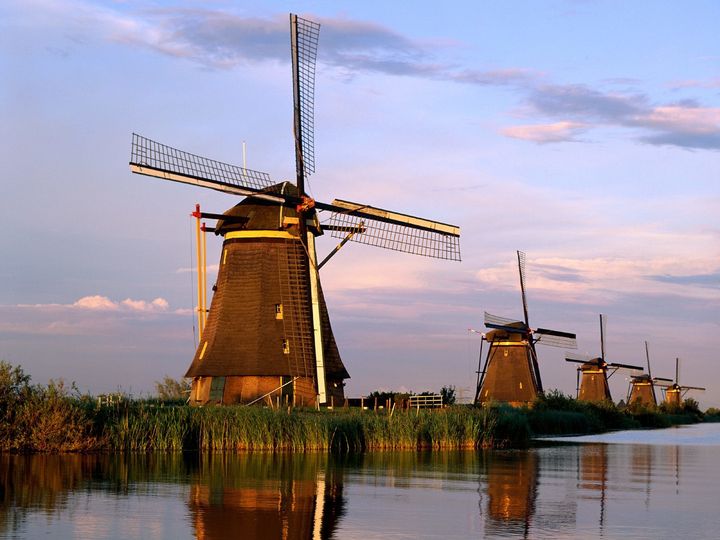 Eighteenth century windmills, once used to drain Holland's fenlands (a type of marsh), are now a UNESCO World Heritage Site in the village of Kinderdijk, the Netherlands.