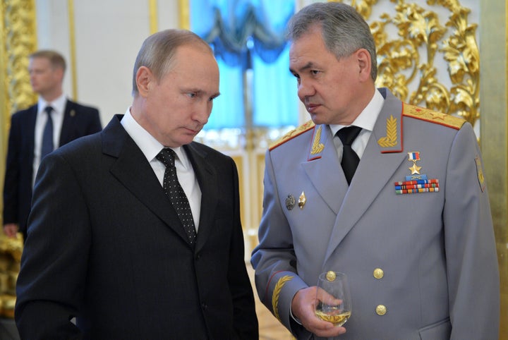 Russian President Vladimir Putin, left, with Defence Minister Sergei Shoigu, who says Moscow has deployed more air defense systems in the southwest and has also deployed a “self-sufficient” contingent of troops in Crimea.