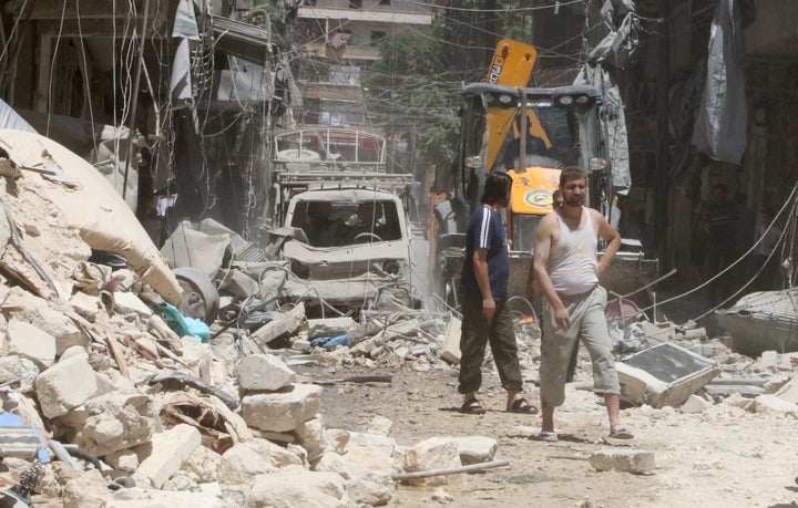 Residents inspect a damaged site after an airstrike on Aleppo's rebel held Al-Mashad neighbourhood, Syria July 26, 2016.