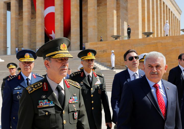 Turkey's Prime Minister Binali Yildirim (R), flanked by Chief of Staff General Hulusi Akar (L) and the country's top generals, leaves Anitkabir the mausoleum of modern Turkey founder Mustafa Kemal Ataturk in Ankara on Thursday.