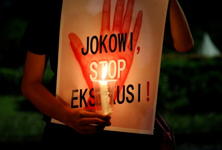 A protester in Jakarta, Indonesia, holds a placard reading, "Jokowi, stop executions," during a demonstration against the impending deaths of 14 inmates on July 28. 