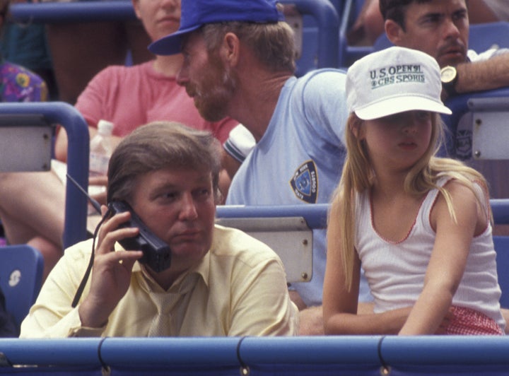 Trump takes a call while attending the 1991 U.S. Open Tennis Championship with daughter Ivanka. 