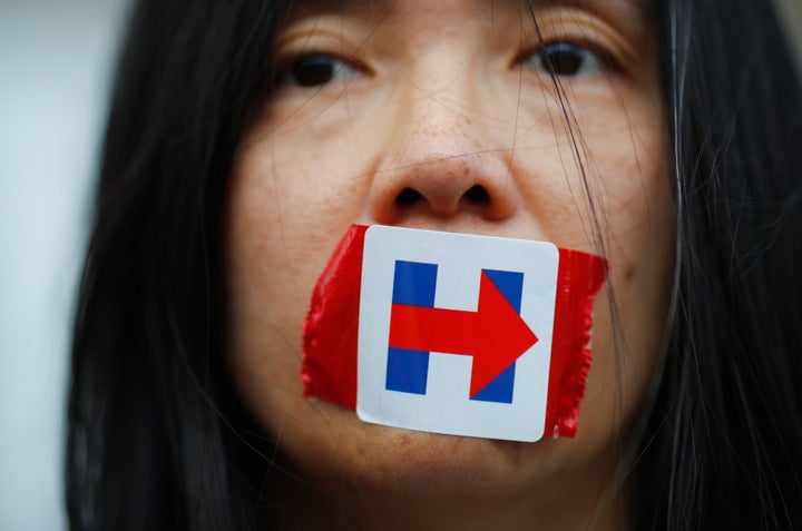 A former Bernie Sanders delegate wears a Clinton campaign sticker over her mouth in protest at the DNC, July 27, 2016.